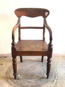 A Scottish Victorian mahogany elbow chair, the shaped crest rail over bar back, down swept arms