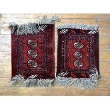 A Pair of Hand Knotted Turkman rugs, the red field with three guls framed in border, 75cm x 56cm