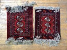 A Pair of Hand Knotted Turkman rugs, the red field with three guls framed in border, 75cm x 56cm