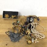 A quantity of costume jewellery including faux pearls, brooches, charm bracelets etc (a lot)