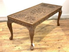 An Anglo-Indian haradwood low table, the top and frieze profusely carved with intertwined foliate,