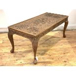 An Anglo-Indian haradwood low table, the top and frieze profusely carved with intertwined foliate,