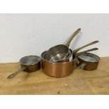 A graduated set of five saucepans with copper bottoms and brass handles (largest: 10cm)