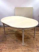 A cream painted Gustavian style extending dining table, the oval top with three leaves, raised on