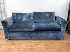 A Contemporary three sofa, with loose cushions, upholstered in a midnight blue crushed velvet