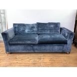 A Contemporary three sofa, with loose cushions, upholstered in a midnight blue crushed velvet