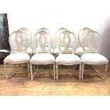 A Set of eight cream painted Gustavian style dining chairs, floral carved crest rail over oval