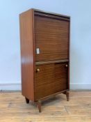 A mid century teak bureau, the fall front revealing Formica writing surface and glass shelf, with