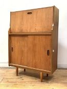 A vintage mid century teak cocktail cabinet, the fall front revealing illuminated interior with