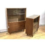 A Vintage mid century teak bookcase, with two sliding glass doors enclosing a shelf, over two