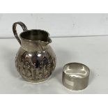 A 19thc London silver milk jug, makers mark JA JS other marks rubbed, with foliate decoration (