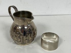 A 19thc London silver milk jug, makers mark JA JS other marks rubbed, with foliate decoration (