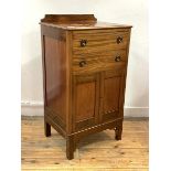 An Edwardian mahogany sheet music cabinet, the raised back over two fall front drawers and a twin