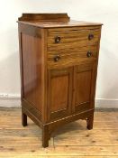 An Edwardian mahogany sheet music cabinet, the raised back over two fall front drawers and a twin