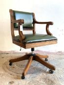 A Reproduction desk chair, studded faux leather upholstered seat and back, reeded open arms,