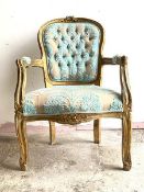 An early 20th century gilt framed fauteuil, the floral carved crest rail over shield back, fluted