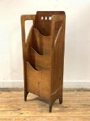 An early 20th century Arts and Crafts period oak three tier magazine holder, with pierced back and