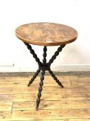 A gypsy table, the circular yew wood top on a bobbin turned ebonised base, H68cm, D52cm