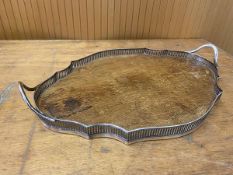 An oak drinks tray the underleading edge with raised pierced metal sides and two handles to either