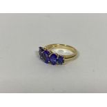 A 10ct gold ring set five graduated oval cut blue/purple stones (O) (5g)