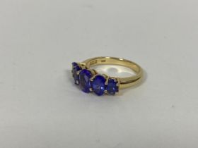 A 10ct gold ring set five graduated oval cut blue/purple stones (O) (5g)