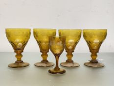 A set of four 19th century amber glass rummers, each with panel cut bowl acid etched with a band