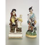 An early 19th century Staffordshire pearlware group of a boy and girl musician, modelled seated on a
