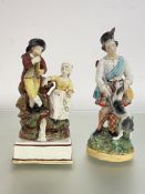An early 19th century Staffordshire pearlware group of a boy and girl musician, modelled seated on a