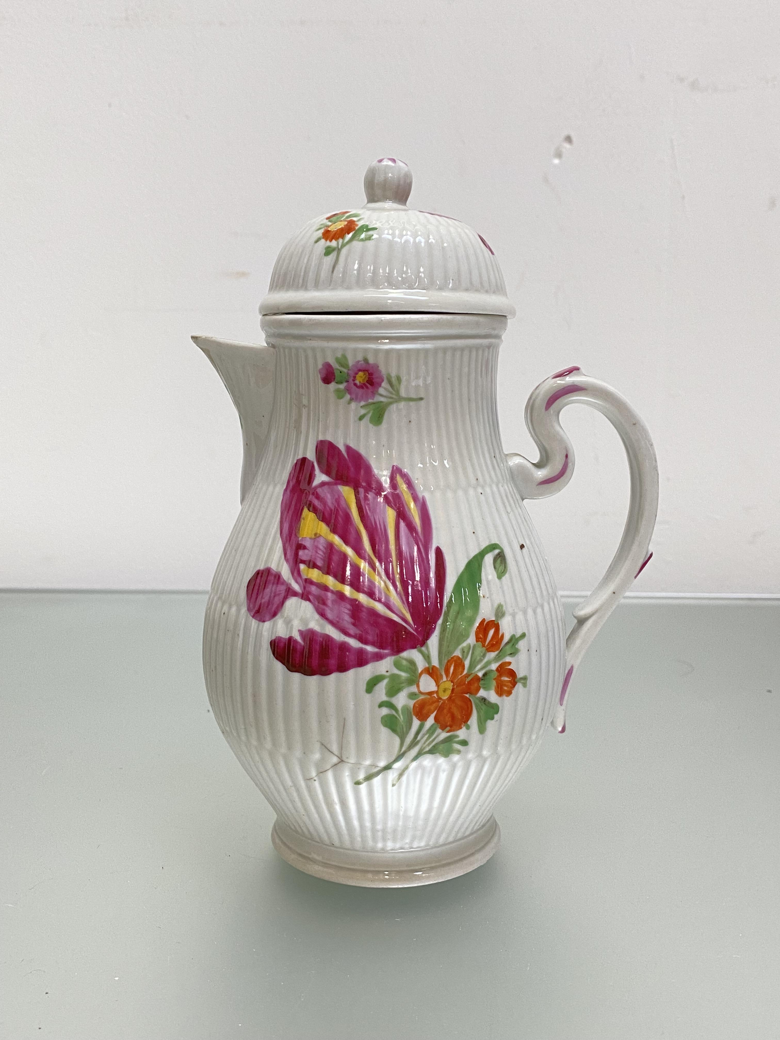 A French porcelain coffee pot in 18th century style, of baluster form, with reeded bands and painted