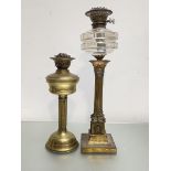 A late 19th century gilt-metal Corinthian columnar oil lamp, with square base and glass reservoir;
