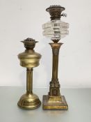 A late 19th century gilt-metal Corinthian columnar oil lamp, with square base and glass reservoir;