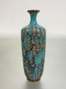 A signed Japanese cloisonne vase decorated with weeping cherry blossom, iris and other flowers