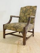 A George III mahogany "Gainsborough" chair, late 18th century, of characteristic form, the downswept