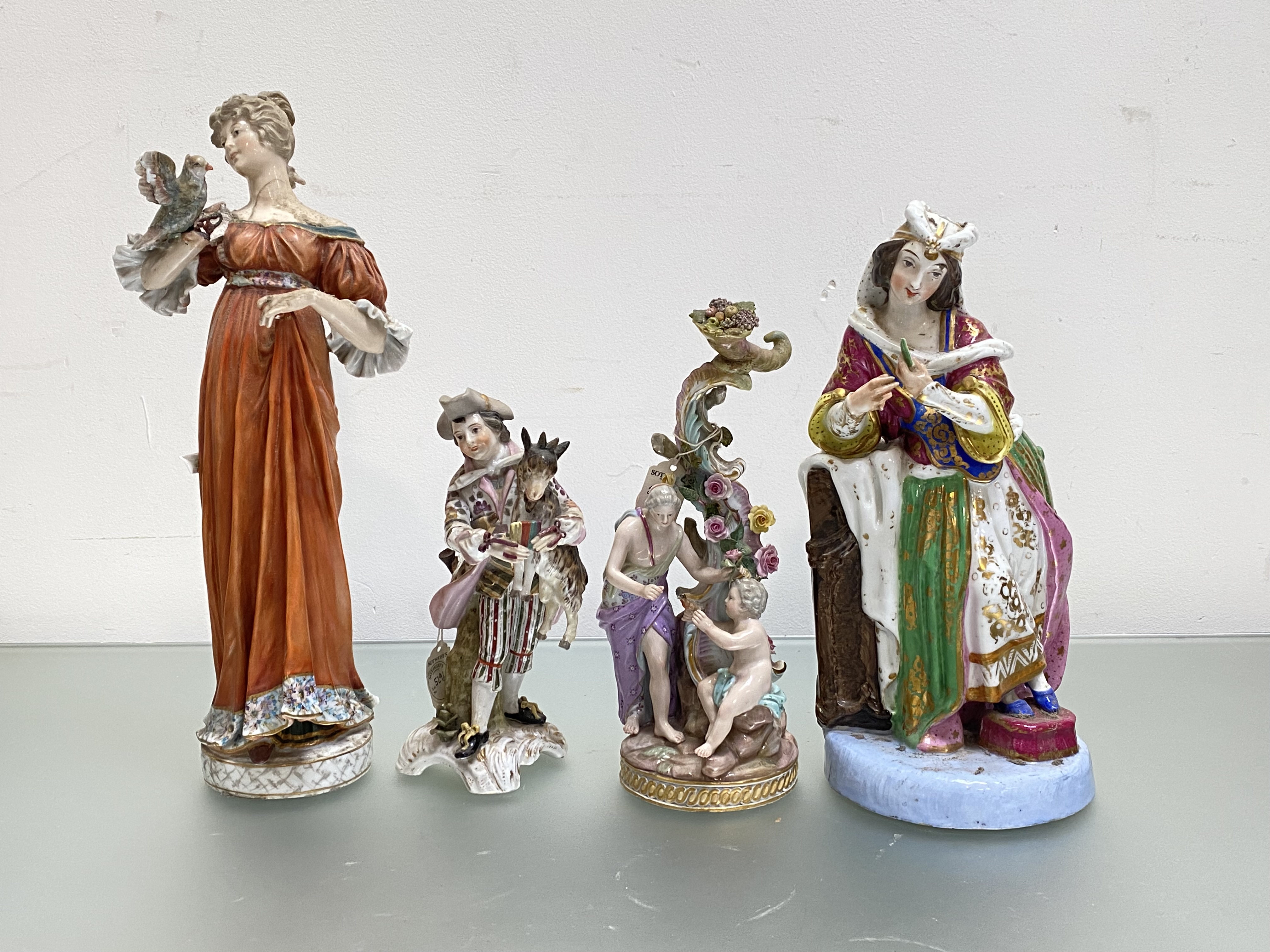 A group of porcelain figures comprising: a 19th century Meissen group of a Classical lady and a