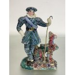 An early 19th century Staffordshire pearlware figure, possibly a theatrical figure, of a man in