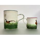 Two Wemyss pottery mugs: the larger painted with pheasants and with green rim, impressed mark; the