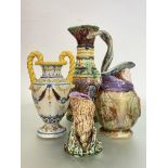 A group of 19th century and later majolica comprising: a large ewer, the body moulded in relief with