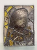 A leaded stained glass panel in late Medieval style, depicting the head of a gentleman. 46cm by