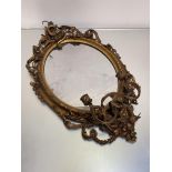 A 19th century giltwood and composition girandole mirror, the oval plate within a conforming frame