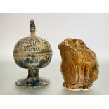 A Scottish pottery money bank, possibly Seaton Pottery, of spherical form on a circular base, in a