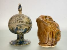 A Scottish pottery money bank, possibly Seaton Pottery, of spherical form on a circular base, in a