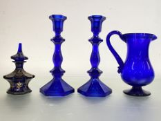 A group of cobalt blue glass comprising: a pair of knopped baluster candlesticks, 20th century; a