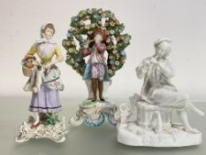 A group of three porcelain figures comprising: a Samson of Paris bocage figure of a boy flautist