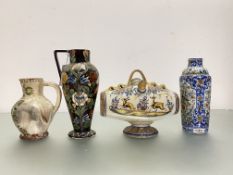 A mixed group of ceramics comprising: two glazed terracotta jugs, one profusely decorated with