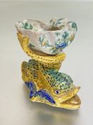 A faience salt, c. 1900, modelled as a shell on a twin dolphin base, unmarked. 10cm by 11.5cm