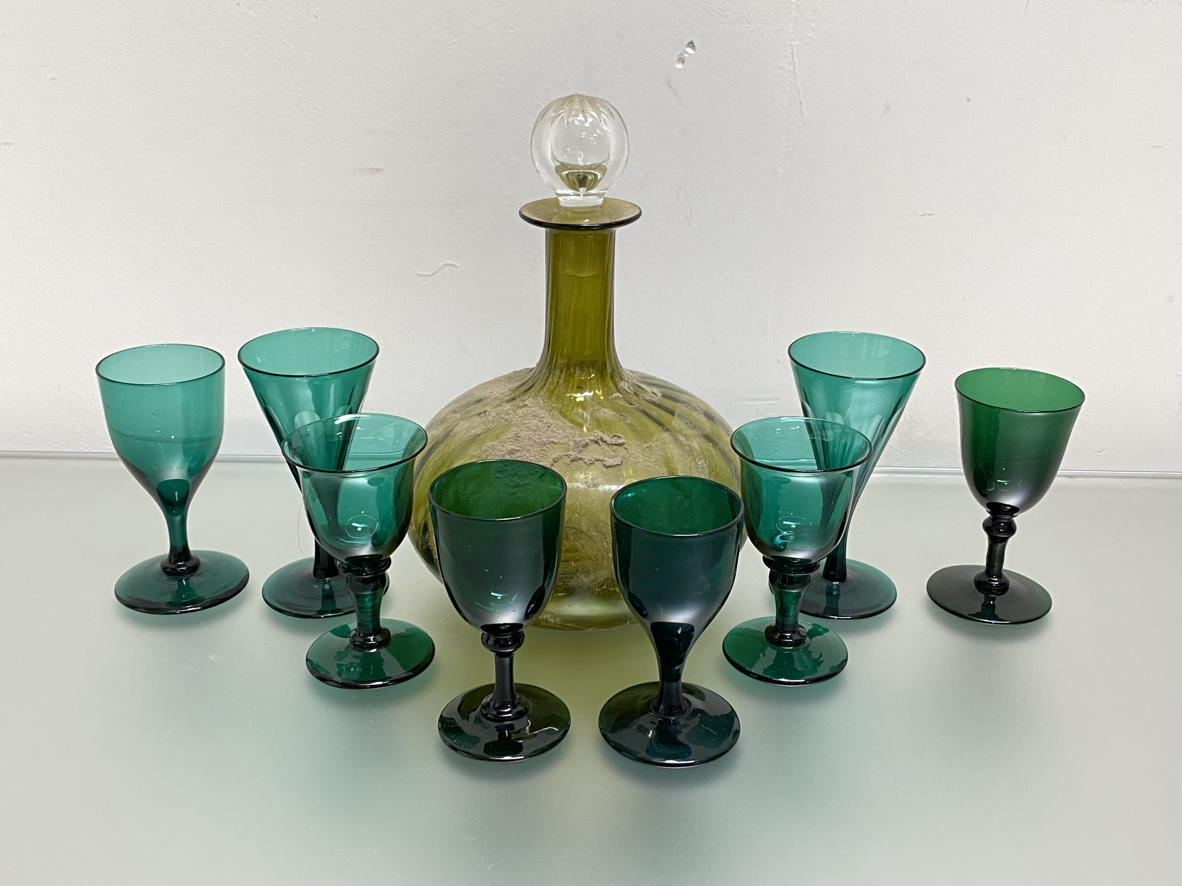 A group of seven 19th century and later green glass wines, of various shapes; together with a