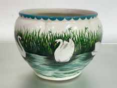 A Wemyss pottery Coombe jardiniere, painted with swans on a river by a reeded bank, impressed