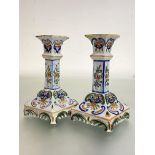 A pair of Rouen faience candlesticks, each with square shaft on a shaped square base. 18cm