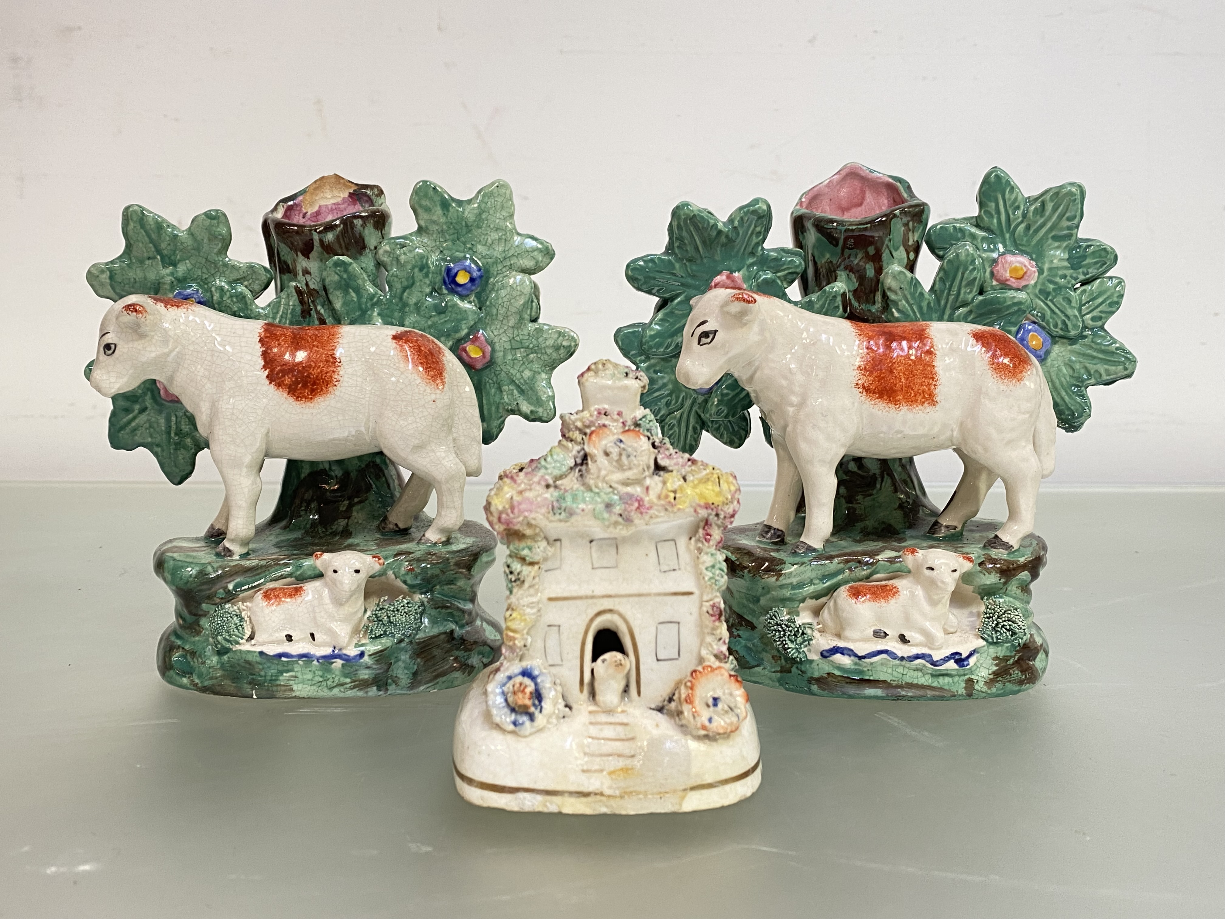 Two 19th century Staffordshire sheep and bocage spill vases, each modelled with ewe before a