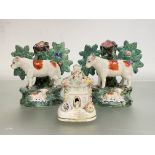 Two 19th century Staffordshire sheep and bocage spill vases, each modelled with ewe before a